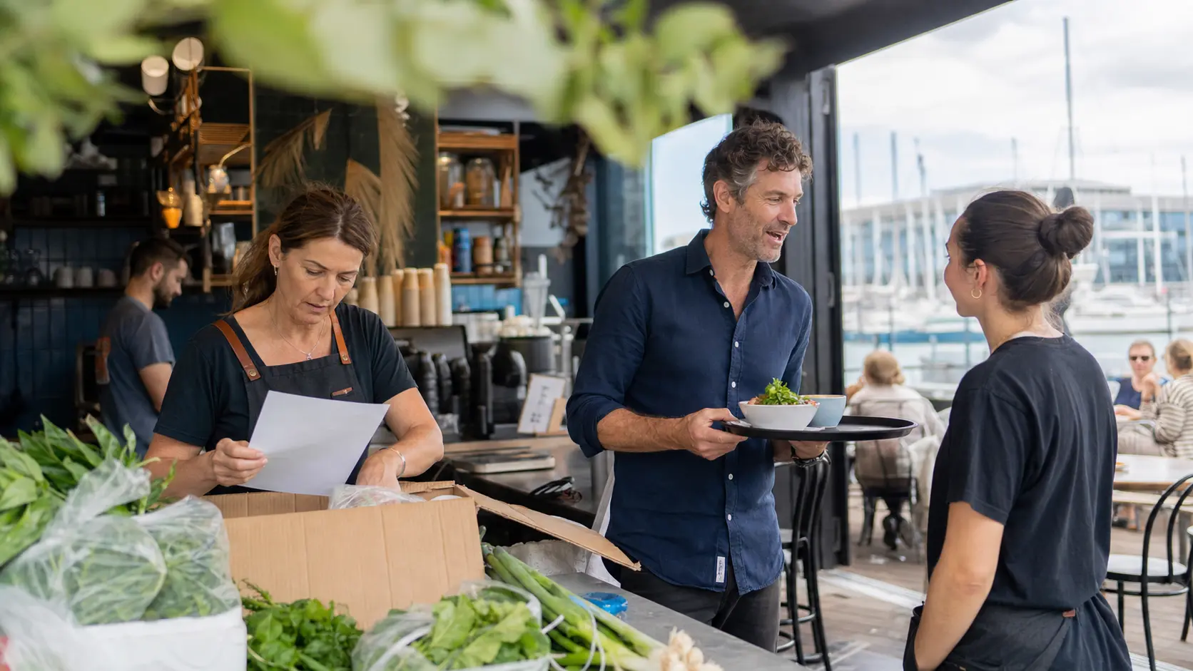 New Zealand owner-operators working in a waterfront Auckland cafe