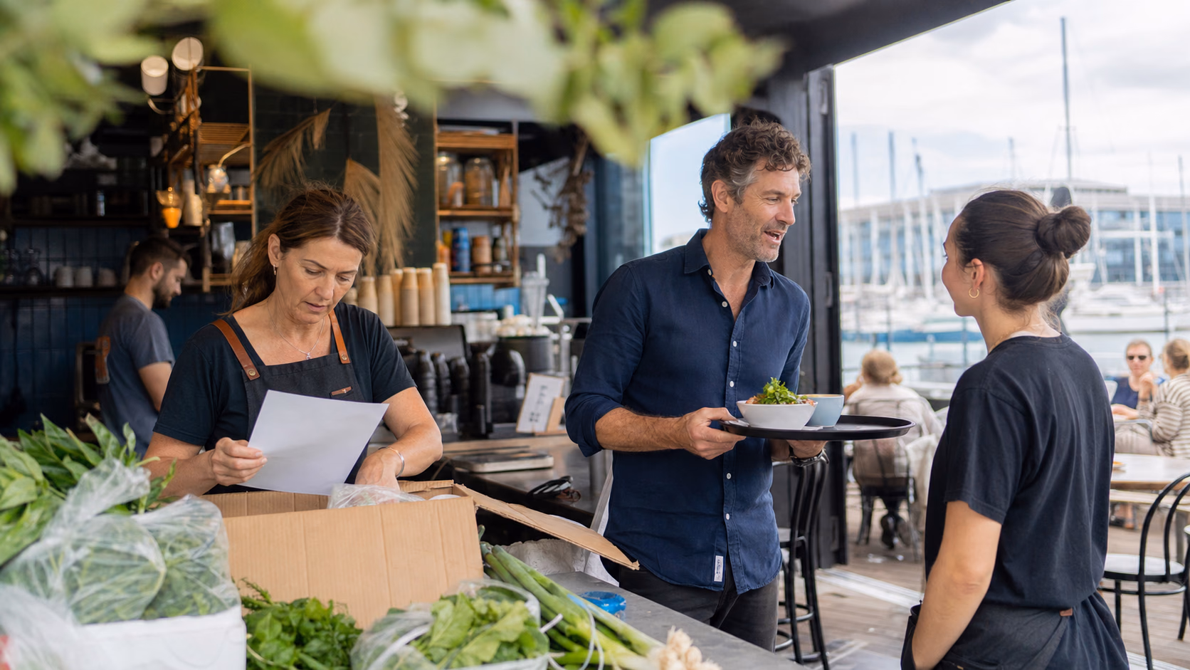 New Zealand owner-operators working in a waterfront Auckland cafe
