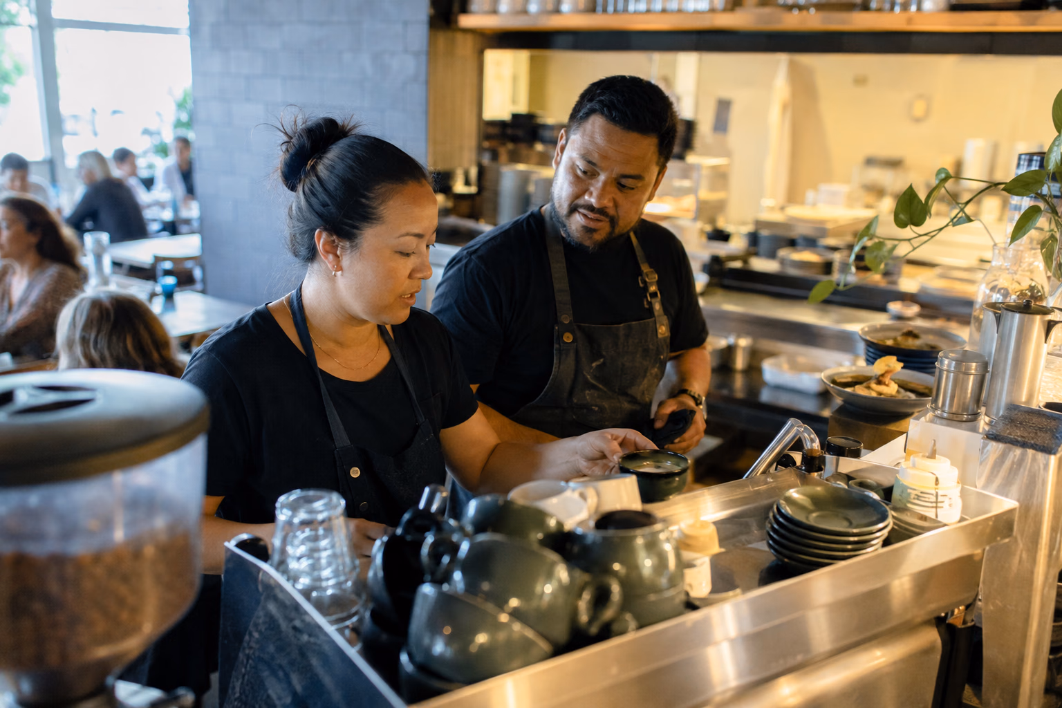 New Zealand cafe owner-operators working during service